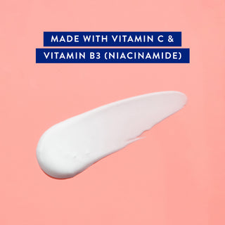Cream swatch on pink background with text: Made with Vitamin C and Vitamin B3 (Niacinamide)