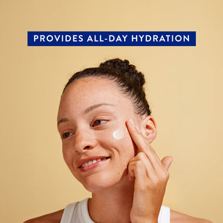 Smiling woman applying moisturizer to cheek with text: Provides long-lasting hydration on beige background