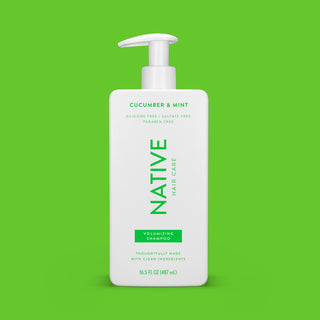 Front of Cucumber & Mint Volumizing Shampoo bottle on pink background