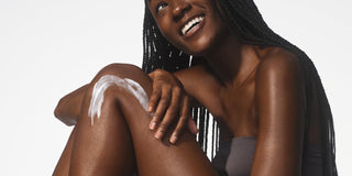 A smiling woman with braided hair applies Native body lotion to her damp skin, illustrating why moisturizing immediately after a shower boosts hydration and how glycerin works, answering "When should you use body lotion" for optimal results