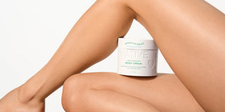 A close-up of a person's legs and arm with a Native Sensitive Series 48HR Hydrating Body Cream jar, illustrating how often to moisturize and the benefits of daily lotion for sensitive skin