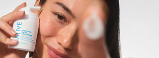 Person holding a bottle of Native moisturizer with a close-up of their face