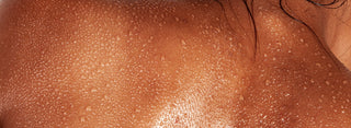 Close-up of a person's shoulder with visible skin texture