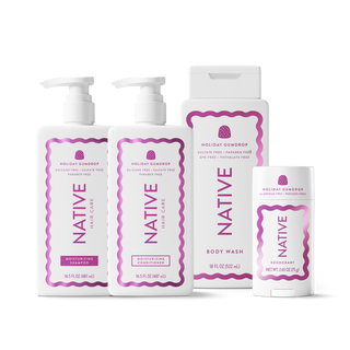 A set of Native Hair Care Holiday Gumdrop products including shampoo, conditioner, body wash, and deodorant in white containers with pink and purple labels, arranged on a white background.