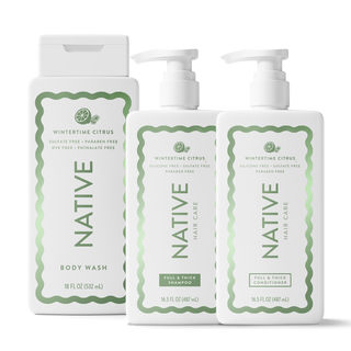 Three white Native Hair Care bottles on a white background: a body wash bottle, a shampoo pump bottle, and a conditioner pump bottle, all labeled Wintertime Citrus with green decorative borders and text.