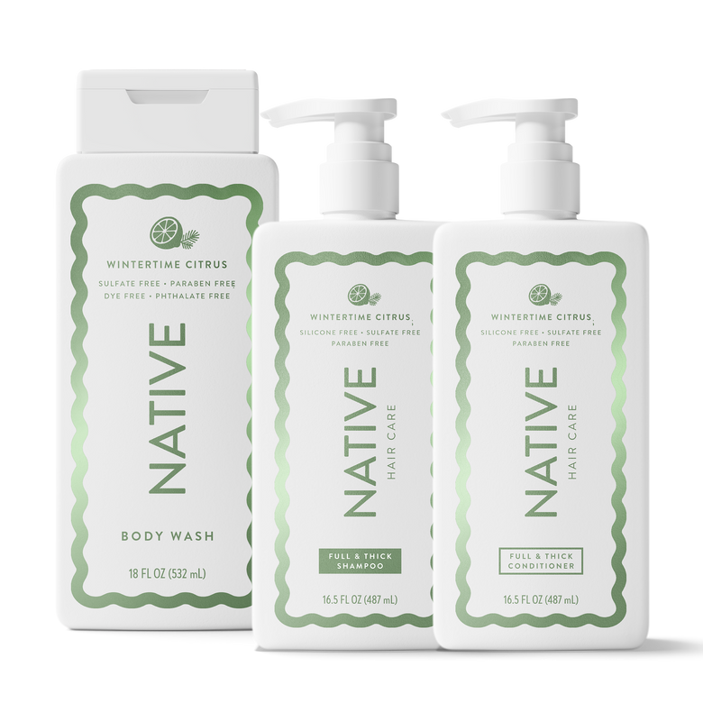 Three white Native Hair Care bottles on a white background: a body wash bottle, a shampoo pump bottle, and a conditioner pump bottle, all labeled Wintertime Citrus with green decorative borders and text.