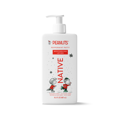 A 16.5 fl oz bottle of Peanuts Peppermint Patty Moisturizing Lotion by Native, featuring a white bottle with a pump dispenser and festive red and black holiday illustrations of Snoopy and Woodstock.