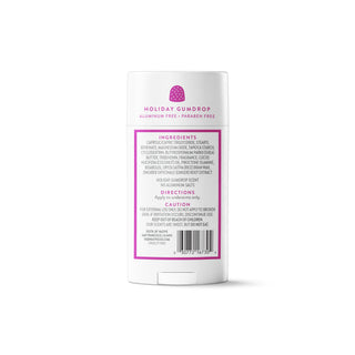 A white plastic deodorant stick container shown from the back, featuring a pink and purple label with the scent name 'Holiday Gumdrop' and product details including ingredients, usage, and a barcode.
