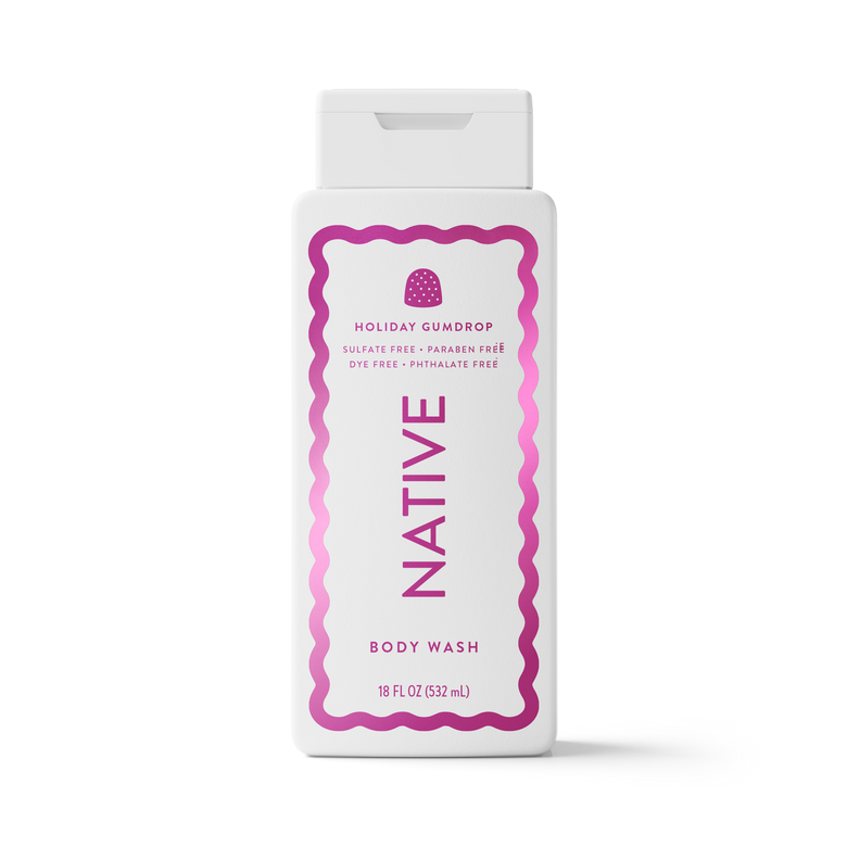 A white plastic bottle of Native Holiday Gumdrop body wash with a white flip-top cap, featuring a pink and magenta wavy border and text on the front label.