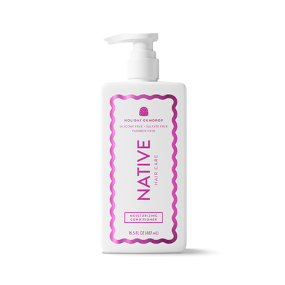 A white plastic pump bottle of Native Hair Care Holiday Scallop Moisturizing Conditioner, featuring a pink wavy border and pink text on the label, set against a plain white background.