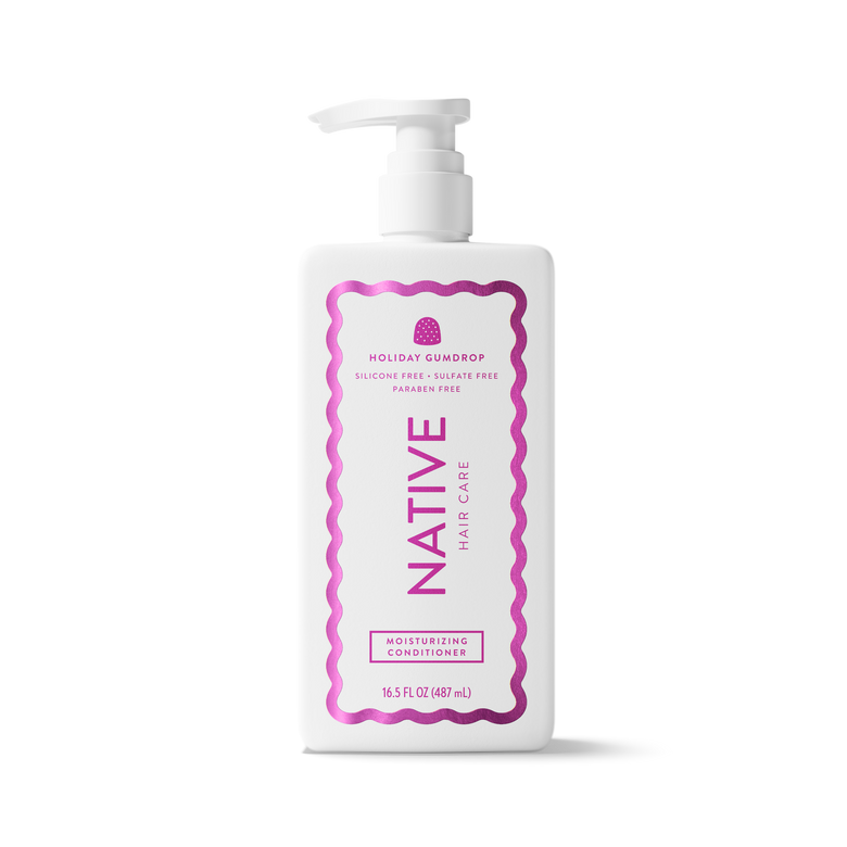 A white plastic pump bottle of Native Hair Care Holiday Scallop Moisturizing Conditioner, featuring a pink wavy border and pink text on the label, set against a plain white background.