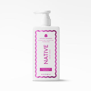 A white plastic pump bottle of Native Hair Care Holiday Squidrop Moisturizing Shampoo, featuring a pink and purple label, on a clean white background.