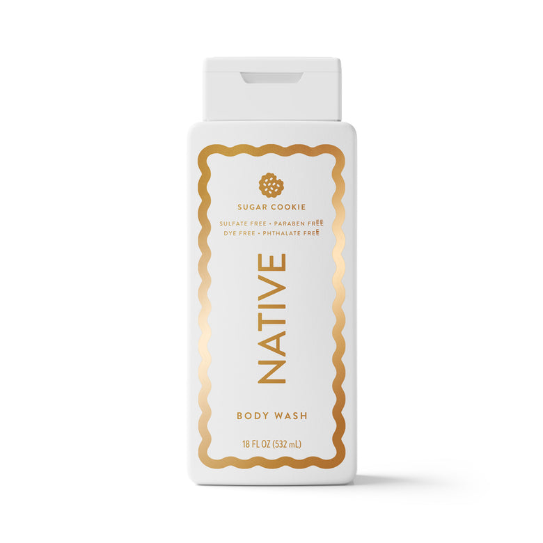 A white bottle of Native Sugar Cookie Body Wash with a white cap, featuring a gold decorative border and gold lettering on the front label, set against a plain white background.