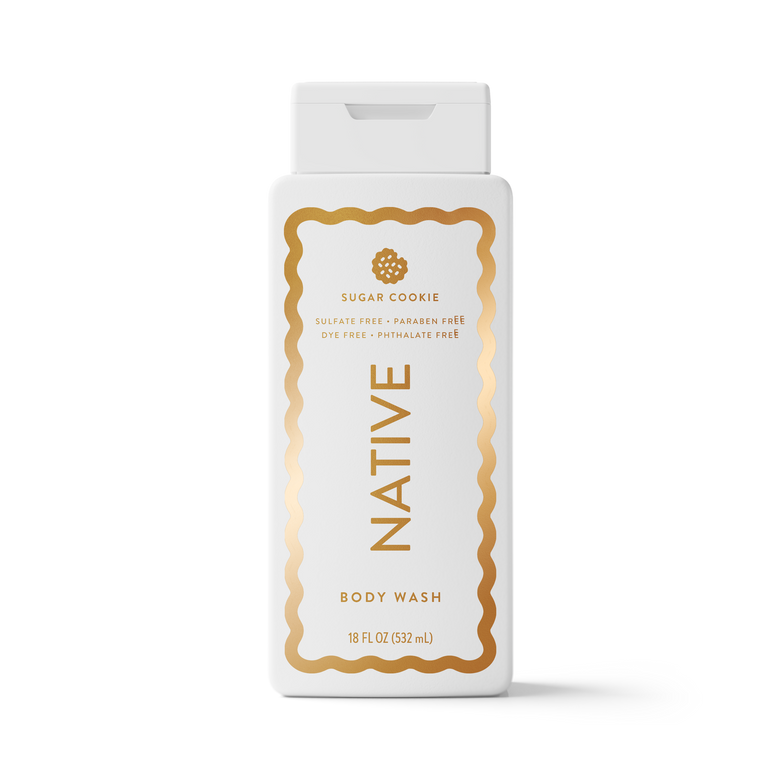 An 18 fl oz bottle of Native Body Wash in the Sugar Cookie scent, featuring a white bottle with a gold decorative border and gold lettering, set against a clean white background.