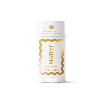 A white Native brand deodorant stick with gold lettering and a gold decorative border on a clean white background.