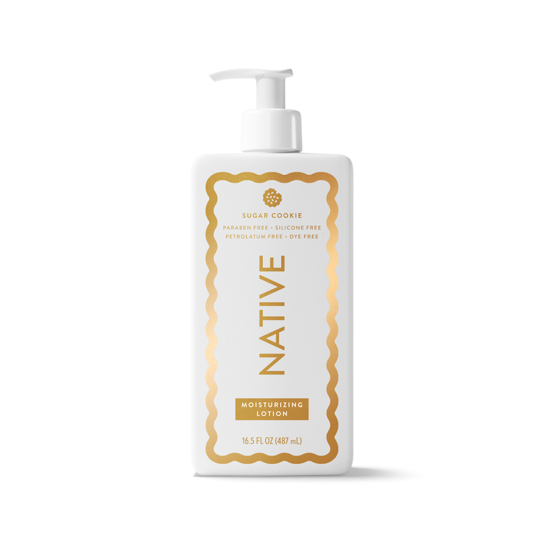 A white pump bottle of Native Sugar Cookie Moisturizing Lotion with a gold decorative border and gold lettering on the label, set against a clean white background.
