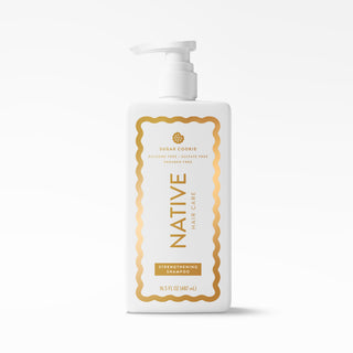 A 16.5 oz white pump bottle of Native Hair Care Sugar Cookie Strengthening Shampoo, featuring a gold and white label, on a clean white background.