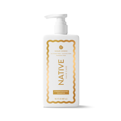 A 16.5 fl oz white plastic bottle of Native Hair Care Sugar Cookie Strengthening Shampoo with a white pump dispenser and gold lettering, set against a clean white background with a soft shadow.