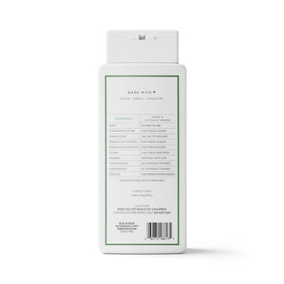 The back of a white plastic bottle with a flip-top cap, featuring a green-bordered ingredient and usage label, shown on a clean white background.
