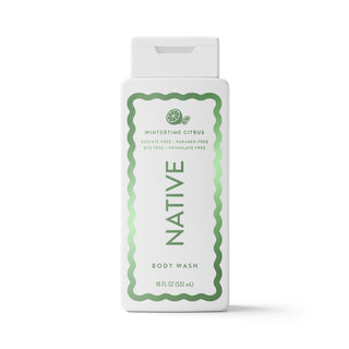 A white plastic bottle of Native Wintertime Citrus body wash with a white cap, featuring a green decorative border and text on the front label, set against a plain white background.