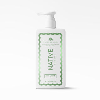 A white pump bottle of Native Hair Care Winterbreeze Citrus Full & Thick Conditioner, featuring a green decorative border and text on a clean white background.