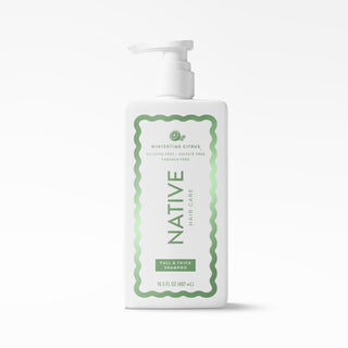 A 16.5 fl oz bottle of Native Hair Care Full & Thick Shampoo in Winterthurst Citrus scent, featuring a white bottle with a green and white label and a white pump dispenser, set against a clean white background.