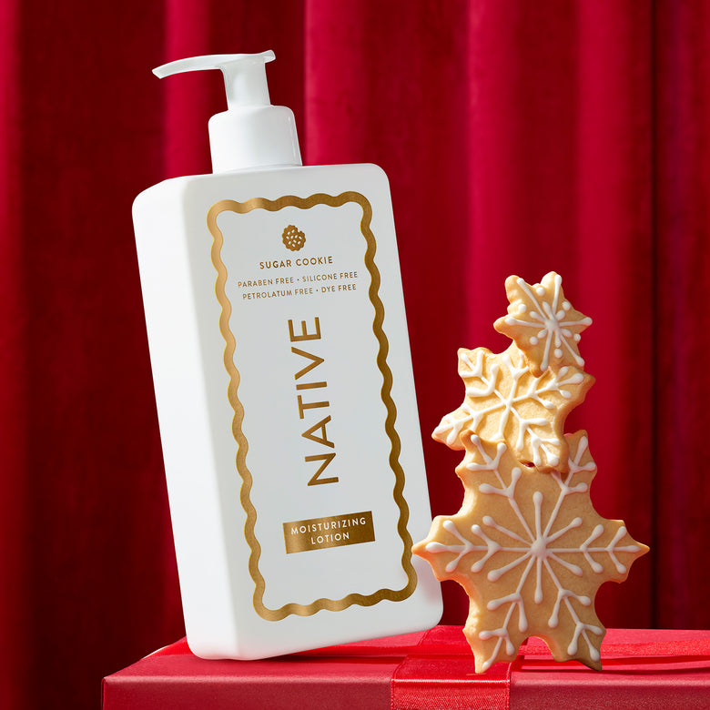 A white pump bottle of Native Sugar Cookie Moisturizing Lotion with a gold decorative border and gold lettering on the label, set against a clean white background.