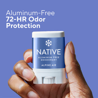 A hand holding a Native Aluminum-Free Deodorant stick labeled Alpine Air, set against a solid blue background with promotional text reading 'Aluminum-Free 72-HR Odor Protection.'.
