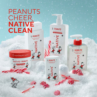 A holiday-themed product lineup from Peanuts featuring Peppermint Patty and Snoopy illustrations on white containers, set in a snowy scene with candy canes and red peppermint candies. The text 'PEANUTS CHEER, NATIVE CLEAN' is displayed at the top left.