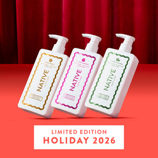 Three white pump bottles of Native Hair Care holiday scented hair oil arranged diagonally on a red surface with a red curtain backdrop. The bottles have gold, pink, and green labels, and a white banner at the bottom reads 'LIMITED EDITION HOLIDAY 2026'.